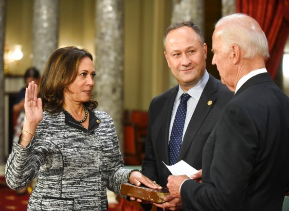 FILE - In this Tuesday, Jan. 3, 2017 file photo, Vice President Joe Biden administers the Senate oath of office to Sen. Kamala Harris, D-Calif., as her husband, Douglas Emhoff, holds the Bible during a mock swearing in ceremony. (AP Photo/Kevin Wolf)