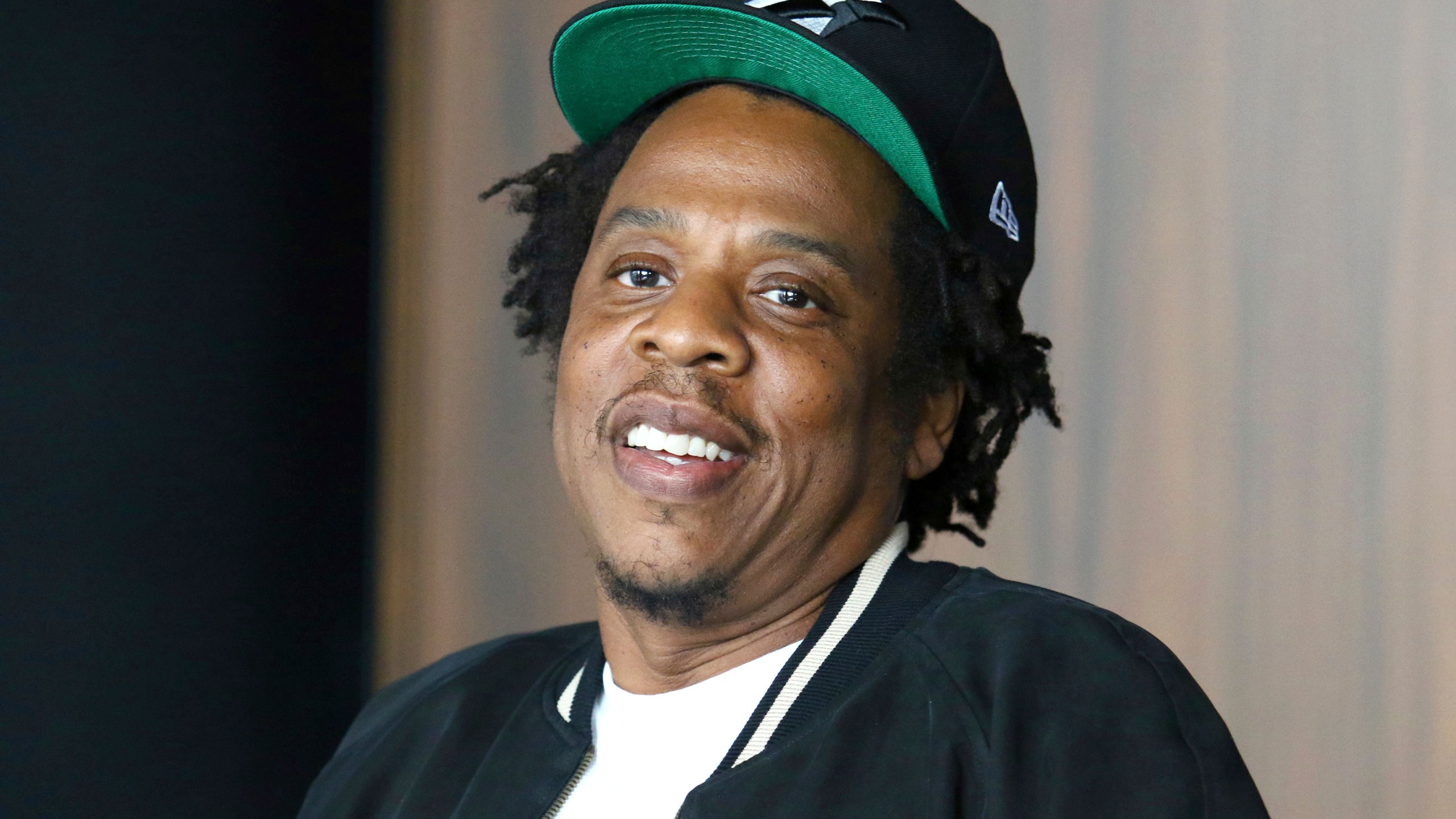 FILE - In this July 23, 2019, file photo, Jay-Z makes an announcement of the launch of Dream Chasers record label in joint venture with Roc Nation, at the Roc Nation headquarters in New York. Moet Hennessy is acquiring a 50% stake in the rapper and entrepreneur's Champagne brand, Armand de Brignac, in an effort to up its cool factor and expand sales. Jay-Z, whose real name is Shawn Carter, said the partnership will help Armand de Brignac grow and flourish.  (Photo by Greg Allen/Invision/AP, File)