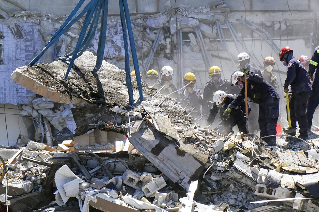 Crews work in the rubble at the Champlain Towers South Condo, Sunday, June 27, 2021, in Surfside, Fla. Many people are still unaccounted for after Thursday's fatal collapse. (AP Photo/Wilfredo Lee)