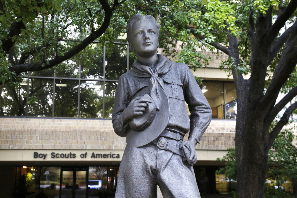 A statue stands outside the Boy Scouts of America headquarters in Irving, Texas. The Boy Scouts of America have reached an agreement with attorneys representing some 60,000 victims of child sex abuse in what could prove to be a pivotal moment in the organization’s bankruptcy case. Attorneys for the BSA filed court papers late Thursday, July 1, 2021 outlining a restructuring support agreement, or RSA, with attorneys representing abuse victims. (AP Photo/LM Otero, File)