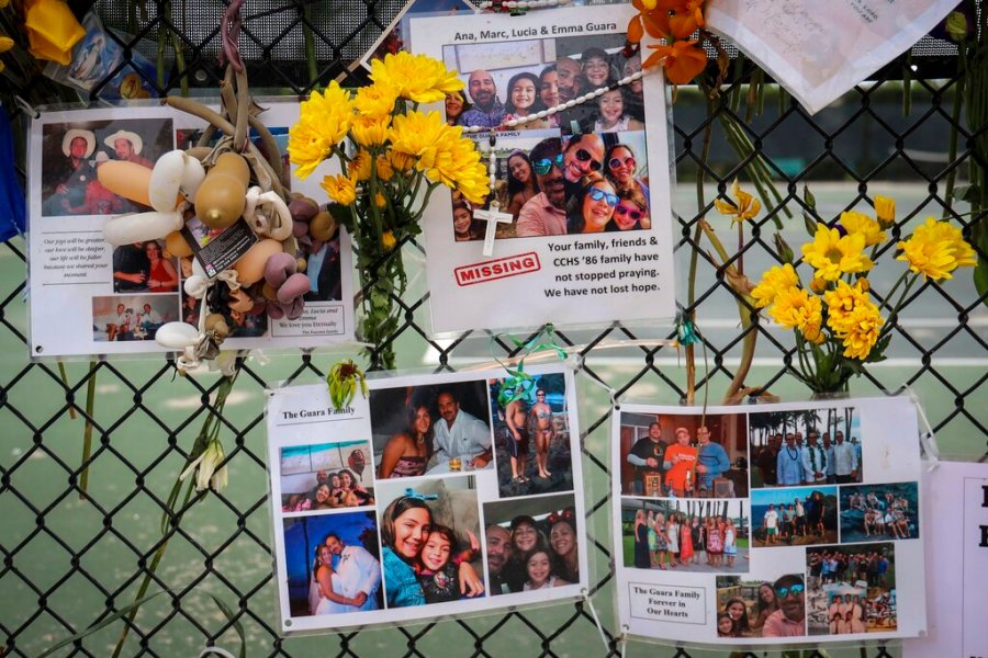 A memorial for the Guara family is posted on a fence near the Champlain Towers South, in Surfside, Fla. Recovery crews at the Florida condominium collapse are cataloging all personal possessions found in the rubble in hopes of returning them to families of the dead or survivors. (Carl Juste/Miami Herald via AP, File)