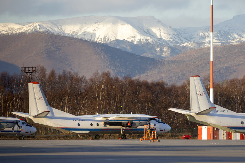 An Antonov An-26 with the same number #RA-26085 as the missed plane is parked at Airport Elizovo outside Petropavlovsk-Kamchatsky, Russia, Tuesday, Nov. 17, 2020. Local officials say the plane with 28 people on board has gone missing in the Russian Far East region of Kamchatka. Emergency officials say the Antonov An-26 plane with 22 passengers and six crew members missed a scheduled communication while it was flying Tuesday from the city of Petropavlovsk-Kamchatsky to the village of Palana. (AP Photo/Marina Lystseva)