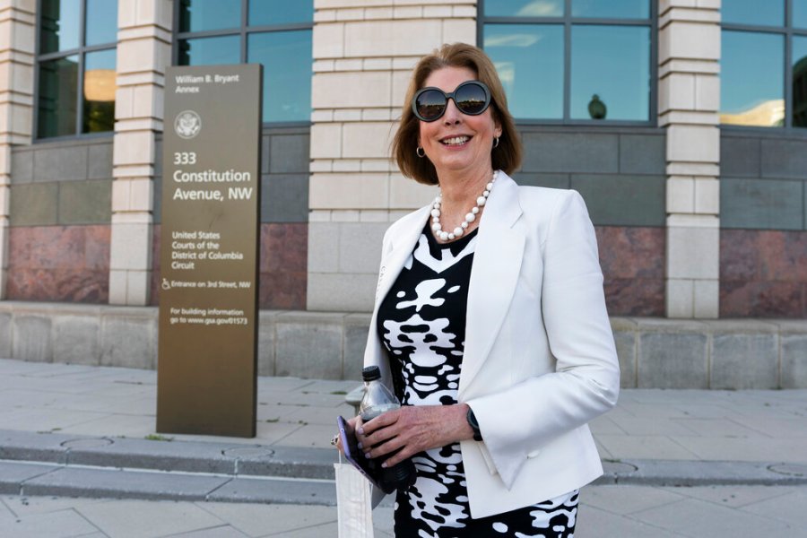 In this June 24, 2021, file photo, former President Donald Trump attorney Sidney Powell leaves federal court in Washington. A federal judge is considering whether to order financial penalties or other sanctions against some of Trump's lawyers, including Powell, who signed onto a lawsuit last year challenging Michigan's election results. (AP Photo/Manuel Balce Ceneta, File)