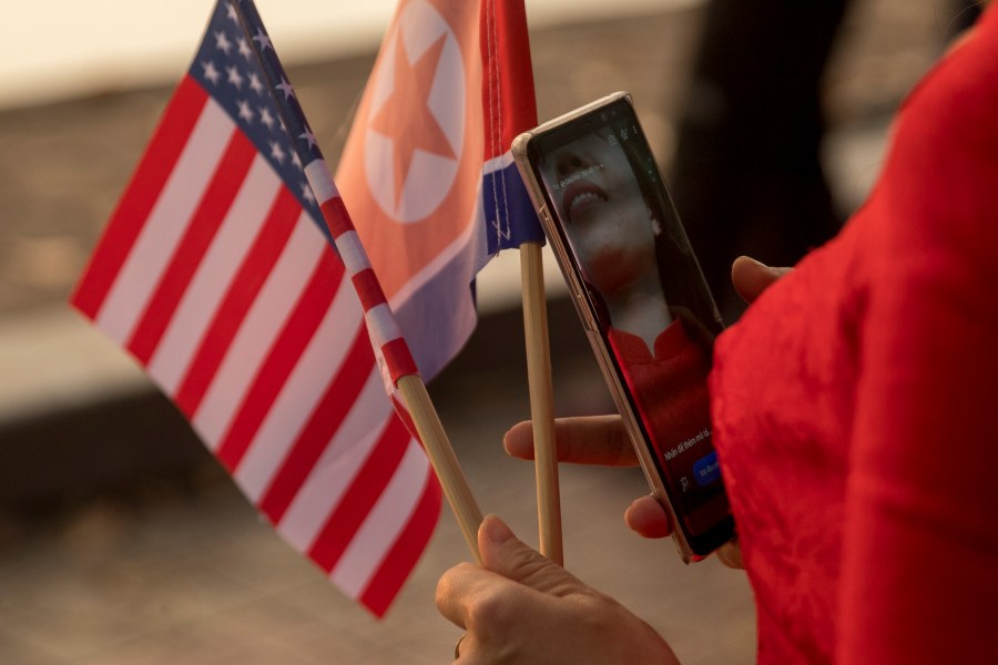 United States and North Korean flags are pictured.