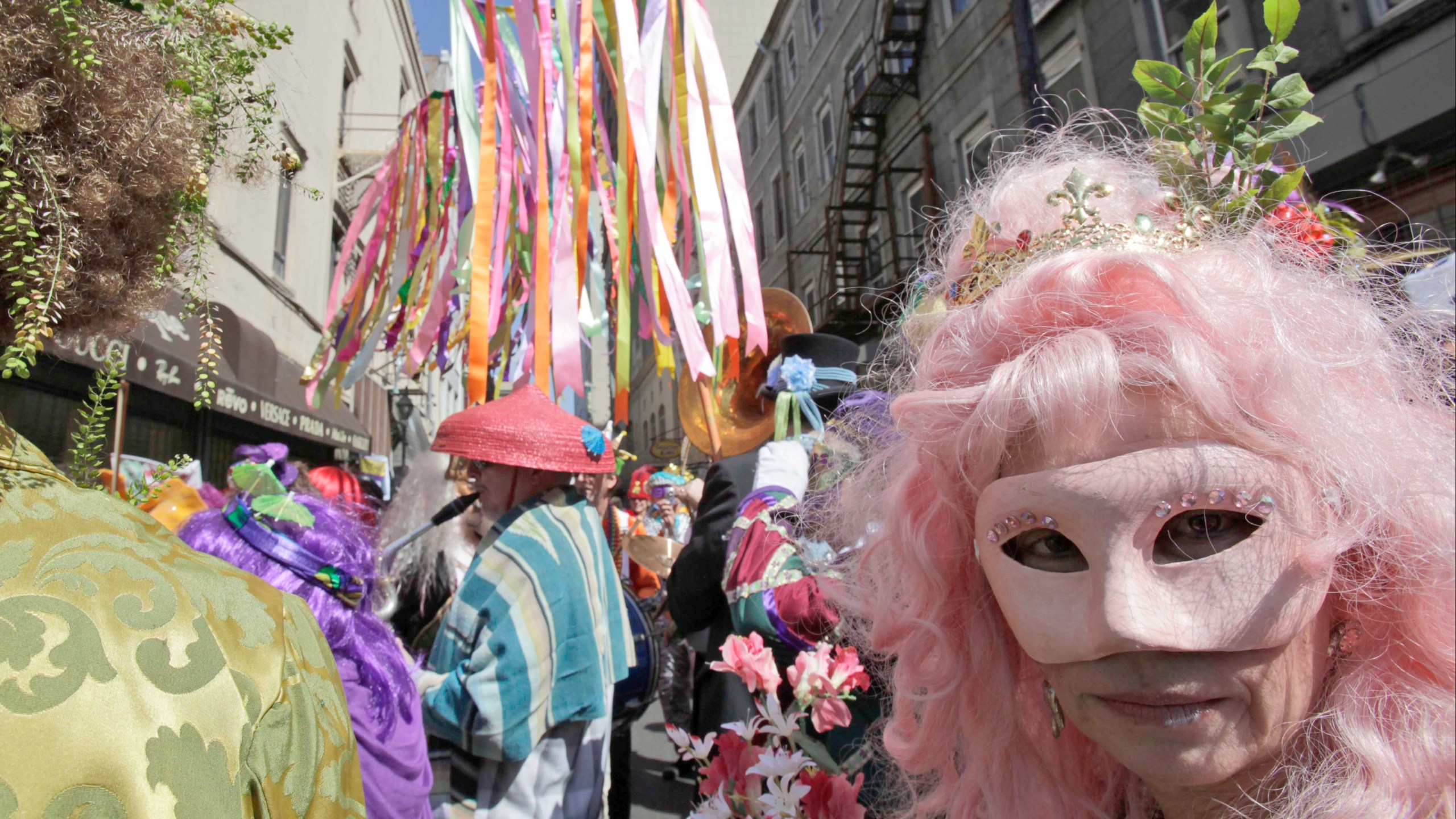 A masked reveler stands with the Society of St. Cecilia on Royal Street on Mardi Gras in the French Quarter of New Orleans, Tuesday, Feb. 24, 2009. Carnival revelers were greeted with clear weather for Mardi Gras.