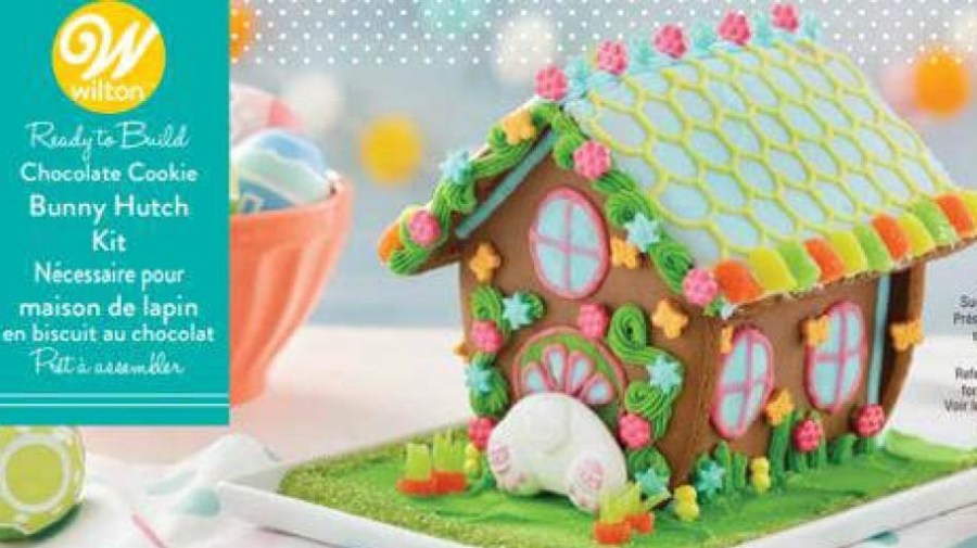 Photo of Wilton Industries' Chocolate Cookie Bunny Hutch kit, which shows an Easter bunny stuck in the doorway of a colorful cookie house