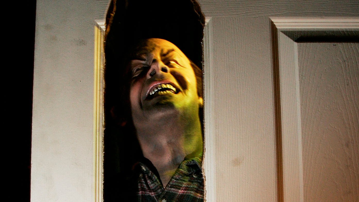 A statue representing Jack Nicholson's character in the 1980 movie "The Shining" peers through a door at the Bayside Exposition in Boston Tuesday, Oct. 25, 2005 where Hallowscream Park, a show combining thousands of glowing jack-o-lanterns and four haunted houses, will run through Saturday. (AP Photo/Elise Amendola)