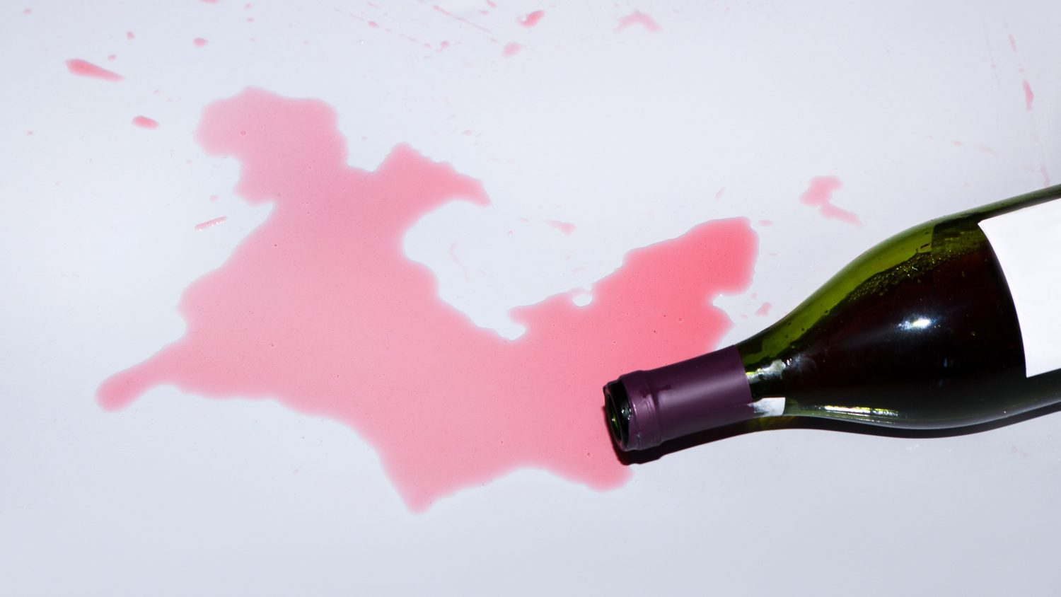 A bottle of red wine knocked over on floor - stock photo (iStock/Getty Images)