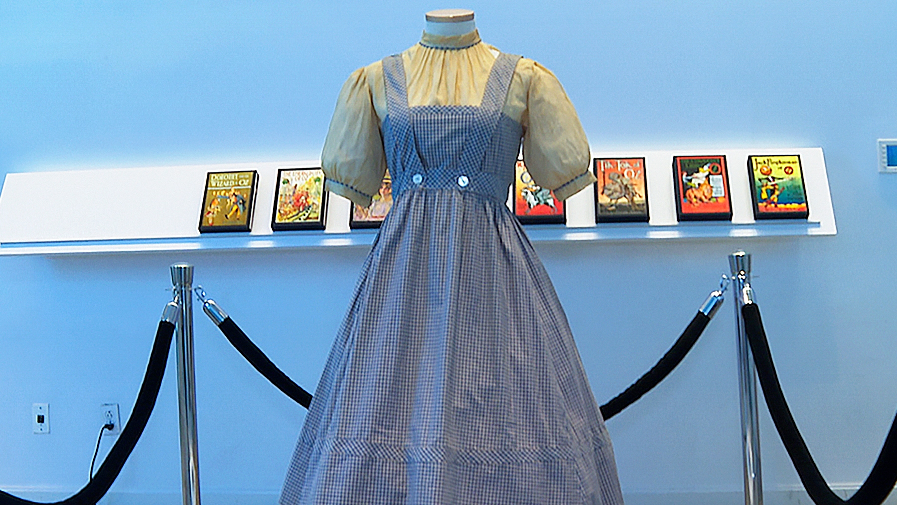 A blue and white checked gingham dress, worn by Judy Garland in the "Wizard of Oz," hangs on display, Monday, April 25, 2022, at Bonhams in New York. One of the most iconic outfits in American movie history is heading for auction, discovered in a box after decades of being thought lost. The dress was found last year at the Catholic University of America, and is on display in New York City before being put up for sale next month by Bonhams. (AP Photo/Katie Vasquez)