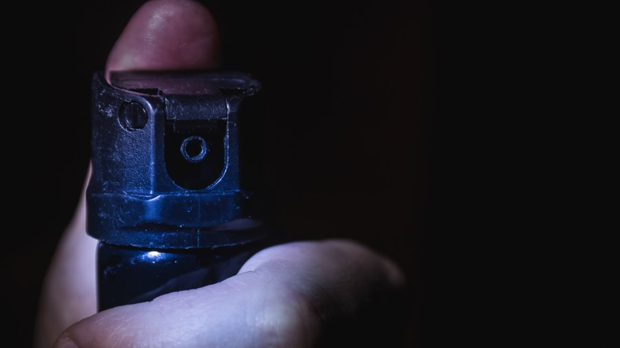 A man's hand holds a gas pepper spray (Getty Images)