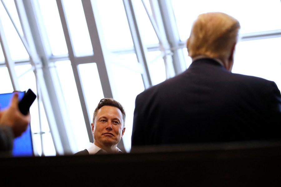 Tesla and SpaceX Chief Executive Officer Elon Musk speaks with President Donald 