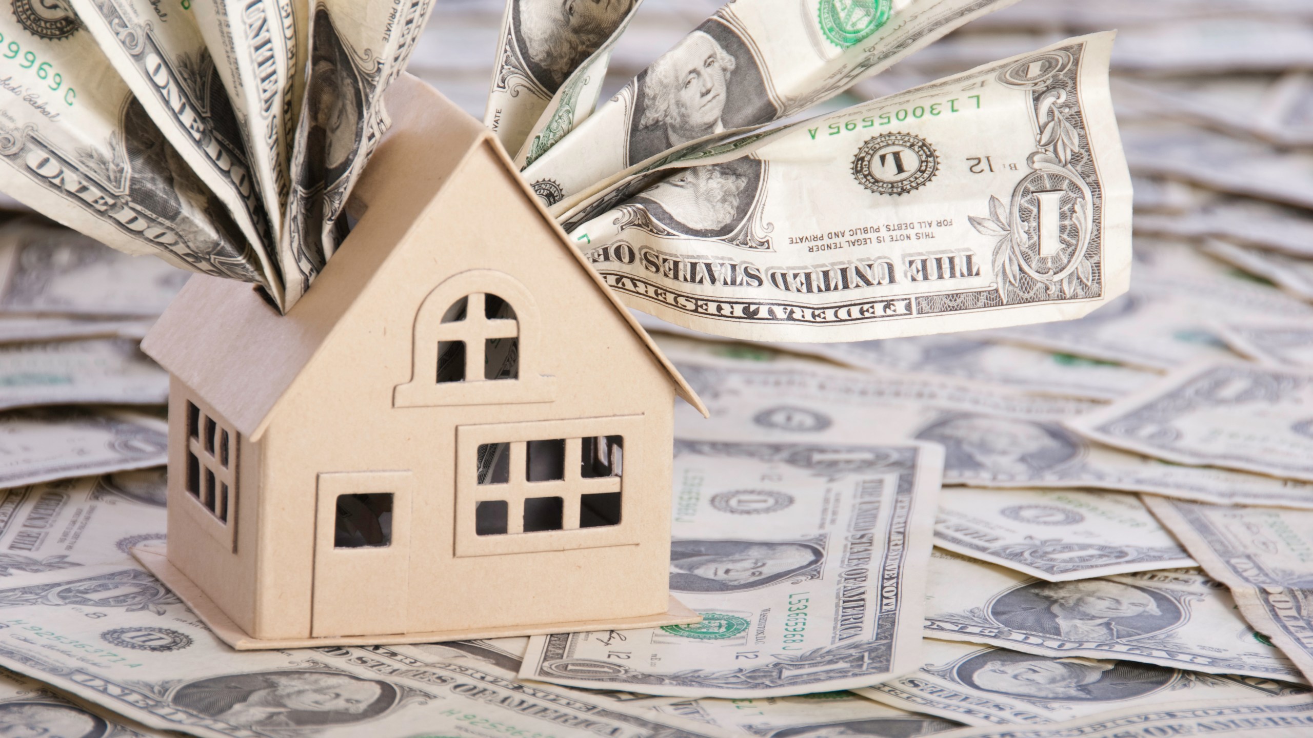 A model house with one dollar bills.