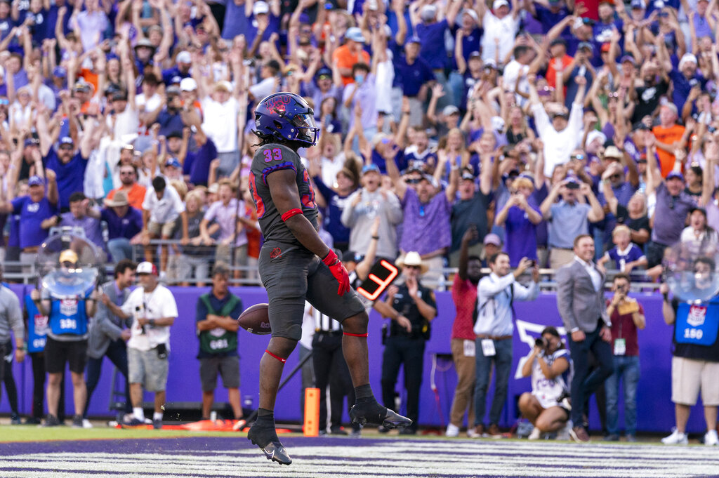 TCU running back Kendre Miller celebrates after scoring the game winning touchdown during the second overtime period of an NCAA college football game against Oklahoma State in Fort Worth, Texas, Saturday.