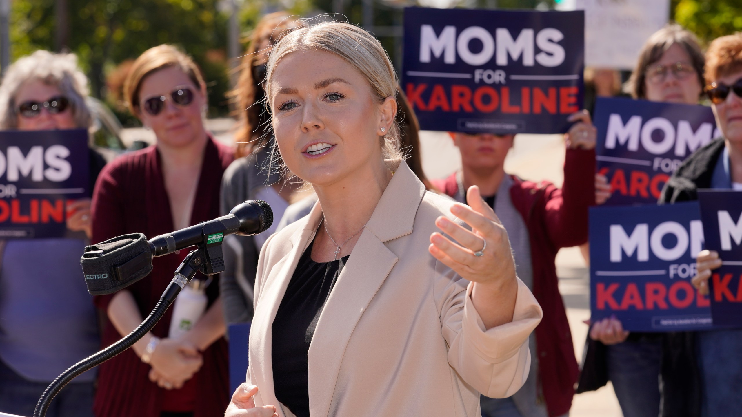 Karoline Leavitt speaks in front of a group of supporters.