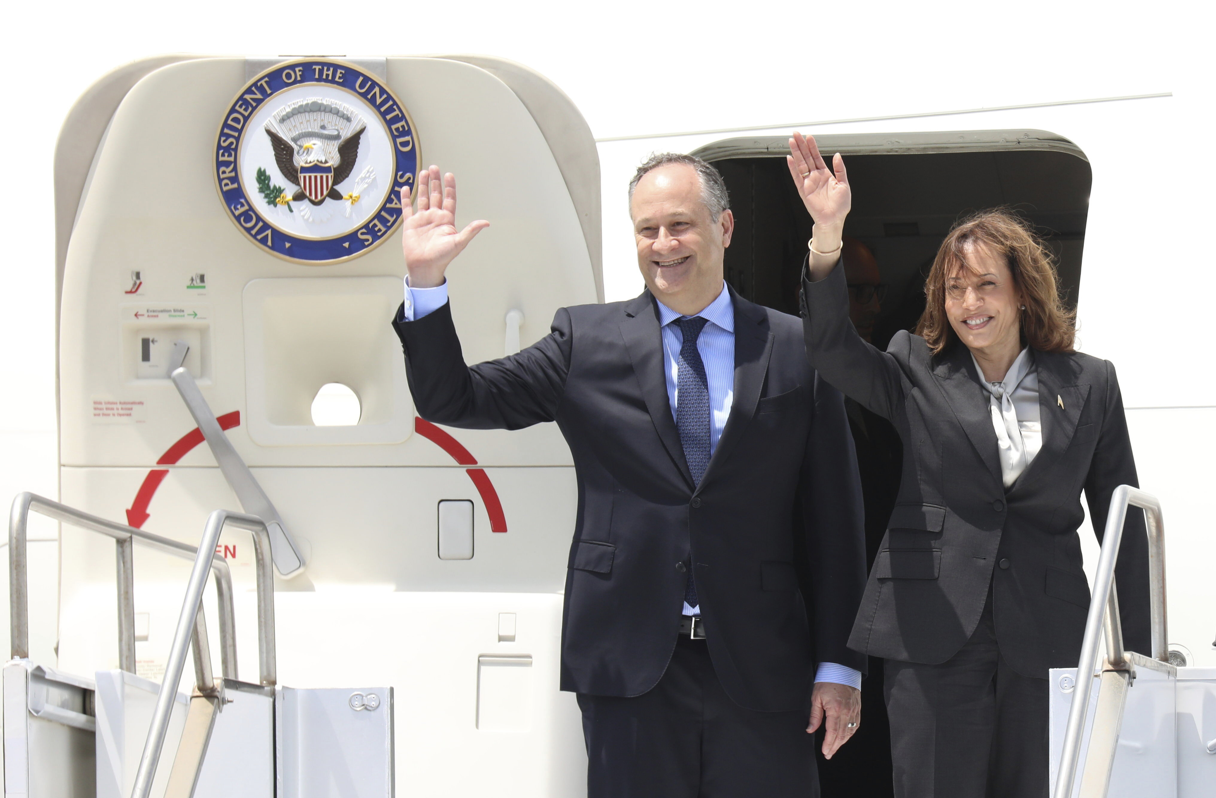 U.S. Vice President Kamala Harris, accompanied by Second Gentleman Doug Emhoff, wave as they depart, at Julius Nyerere Airport, in Dar es Salaam, Tanzania, Friday, March 31, 2023. Harris will visit Zambia on Friday for the final stop of her weeklong trip across Africa. (Emmanuel Herman/Pool Photo via AP)