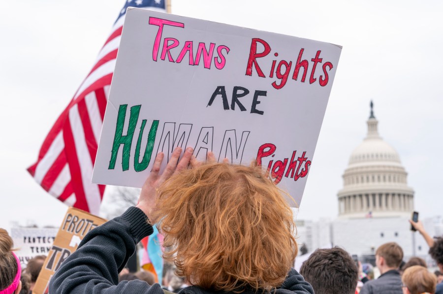 FILE - People attend a rally as part of a Transgender Day of Visibility, Friday, March 31, 2023, by the Capitol in Washington. Schools and colleges across the U.S. would be forbidden from enacting outright bans on transgender athletes under a proposal released Thursday, April 6, from the Biden administration, but teams could create some limits in certain cases, for example, to ensure fairness. (AP Photo/Jacquelyn Martin, File)