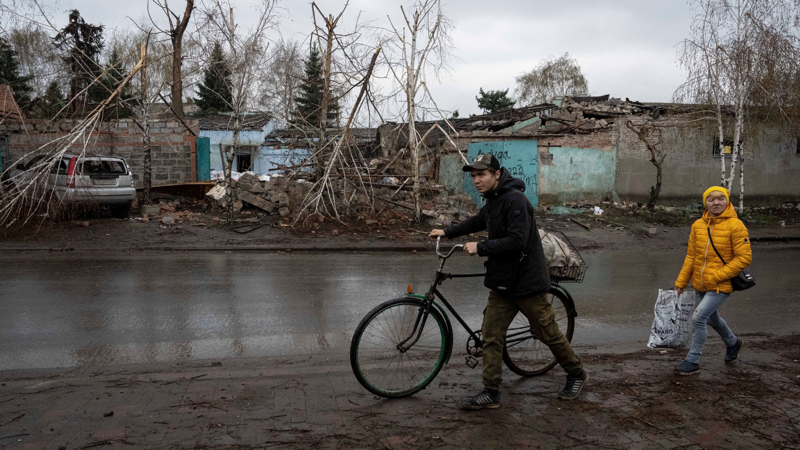 Locals walk past a house which was destroyed by Russian attack in Kostiantynivka, Ukraine, Thursday, April 6, 2023. (AP Photo/Evgeniy Maloletka)