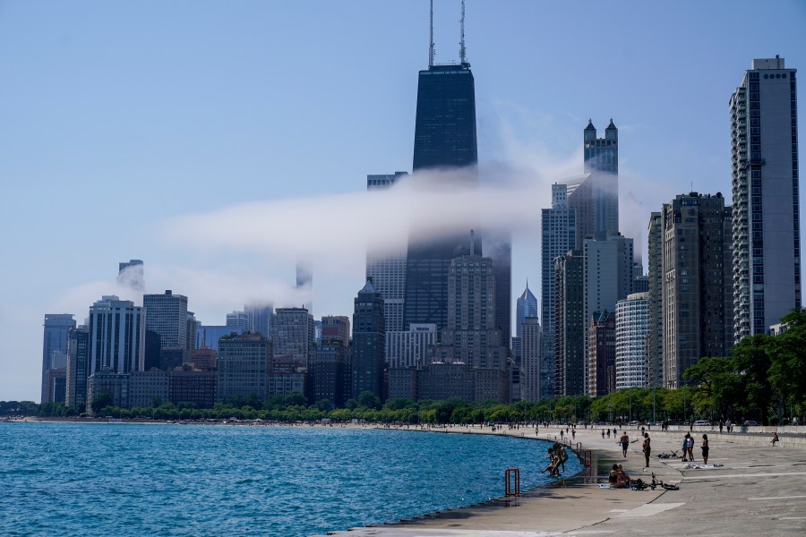 The Chicago city skyline is covered by the fog lifted off Lake Michigan.