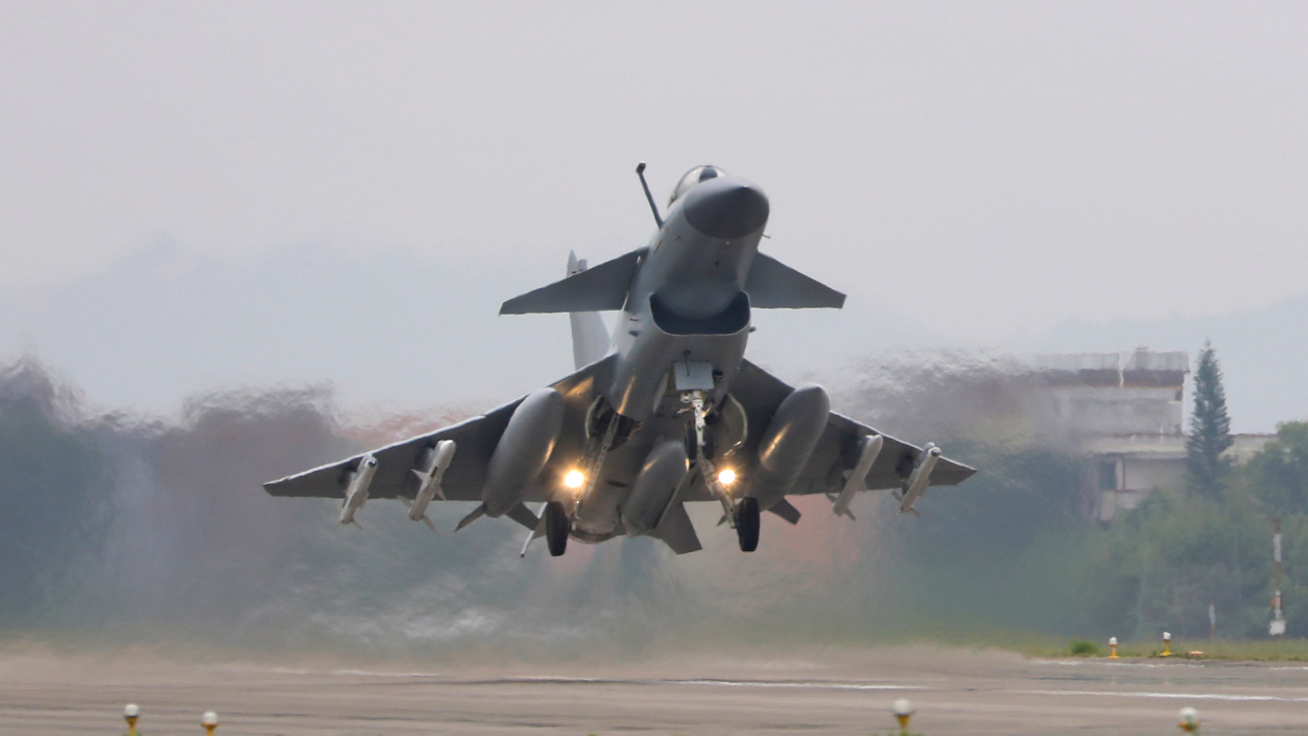 In this photo released by Xinhua News Agency, a fighter takes off during the combat readiness patrol and military exercises around the Taiwan Island carried out by the Eastern Theater Command of the Chinese People's Liberation Army (PLA) from Nanjing in eastern China on April 8, 2023. Recent Chinese air and sea drills simulating an encirclement of Taiwan were intended as a "serious warning" to pro-independence politicians on the self-governing island and their foreign supporters, a Chinese spokesperson said Wednesday, April 12, 2023. (Wang Zixiao/Xinhua via AP)