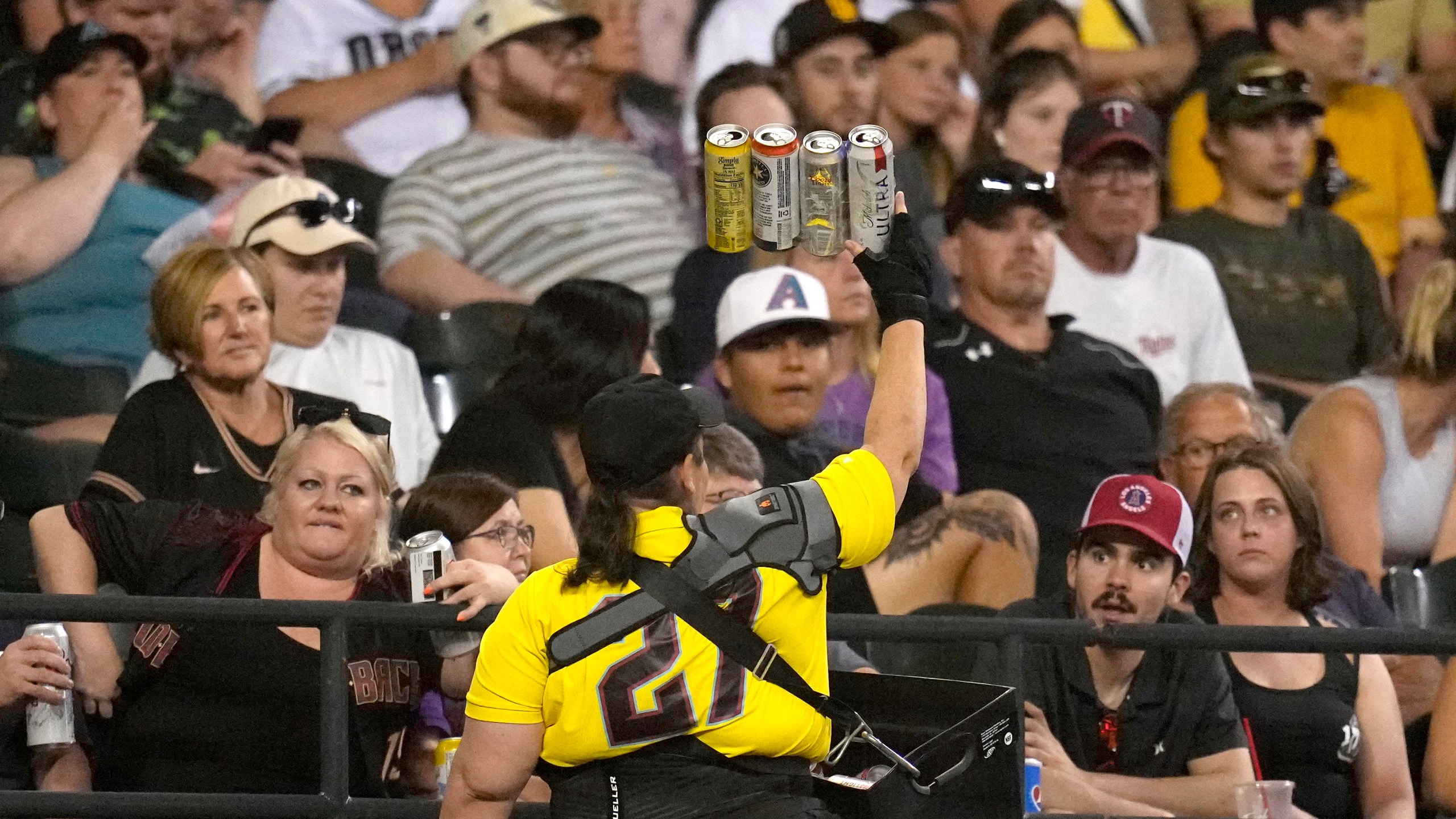 A beer vendor walks through the stands during the seventh inning of a baseball game between the Arizona Diamondbacks and the Milwaukee Brewers Tuesday, April 11, 2023, in Phoenix. (AP Photo/Ross D. Franklin)