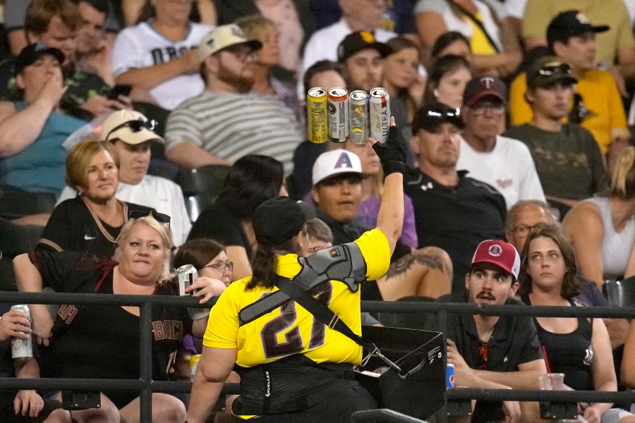 A beer vendor walks through the stands during the seventh inning of a baseball game between the Arizona Diamondbacks and the Milwaukee Brewers Tuesday, April 11, 2023, in Phoenix. (AP Photo/Ross D. Franklin)