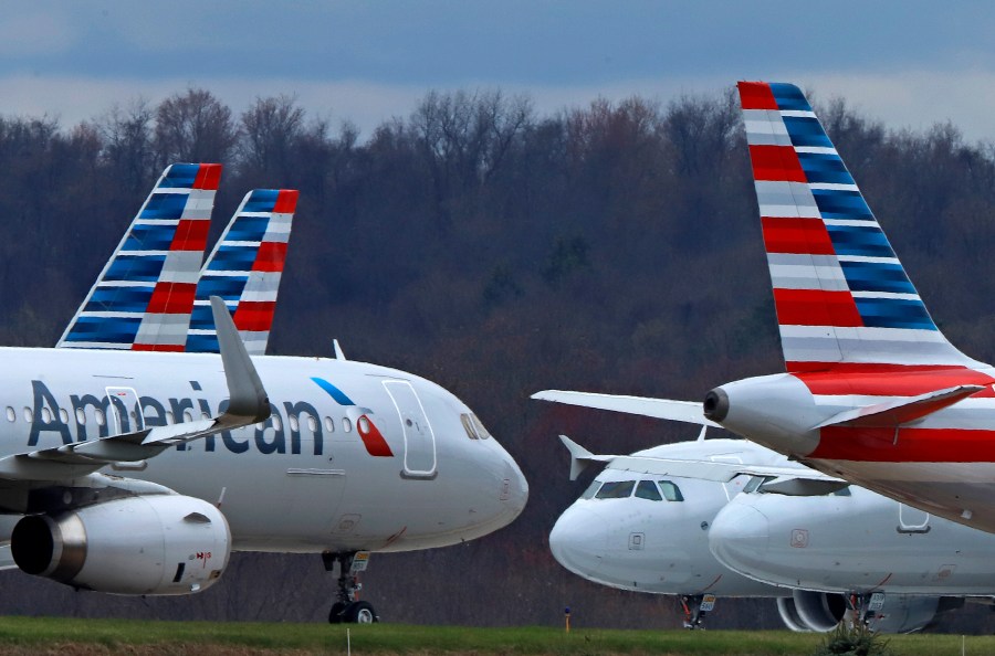 FILE - In this March 31, 2020 file photo American Airlines planes are parked at Pittsburgh International Airport in Imperial, Pa. Shares of American Airlines are falling on word from the carrier that first-quarter profit could be below Wall Street expectations. American said Wednesday, April 12, 2023 that it expects to earn between a penny and 5 cents per share for the quarter that just ended. That leaves room for American to fall short of analysts' prediction that the airline would earn 5 cents per share. (AP Photo/Gene J. Puskar, file)