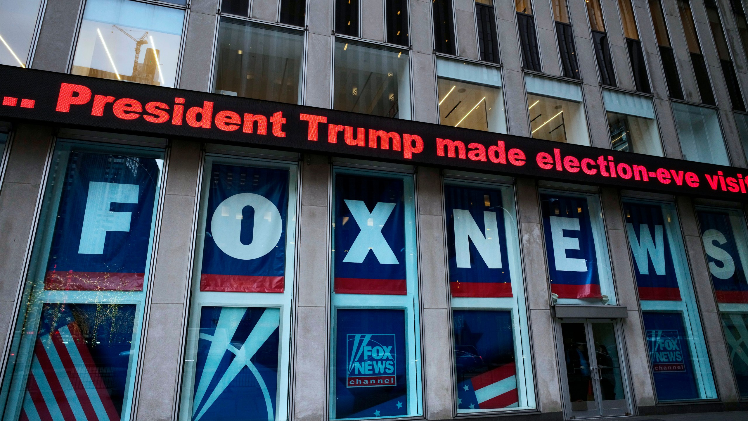 FILE - A headline about President Donald Trump is displayed outside Fox News studios in New York on Nov. 28, 2018. The Delaware judge overseeing Dominion Voting Systems' $1.6 billion defamation lawsuit against Fox News announced late Sunday, April 16, that he was delaying the start of the trial until Tuesday, April 18. He did not cite a reason. The trial, which has drawn international interest, had been scheduled to start Monday morning with jury selection and opening statements. (AP Photo/Mark Lennihan, File)