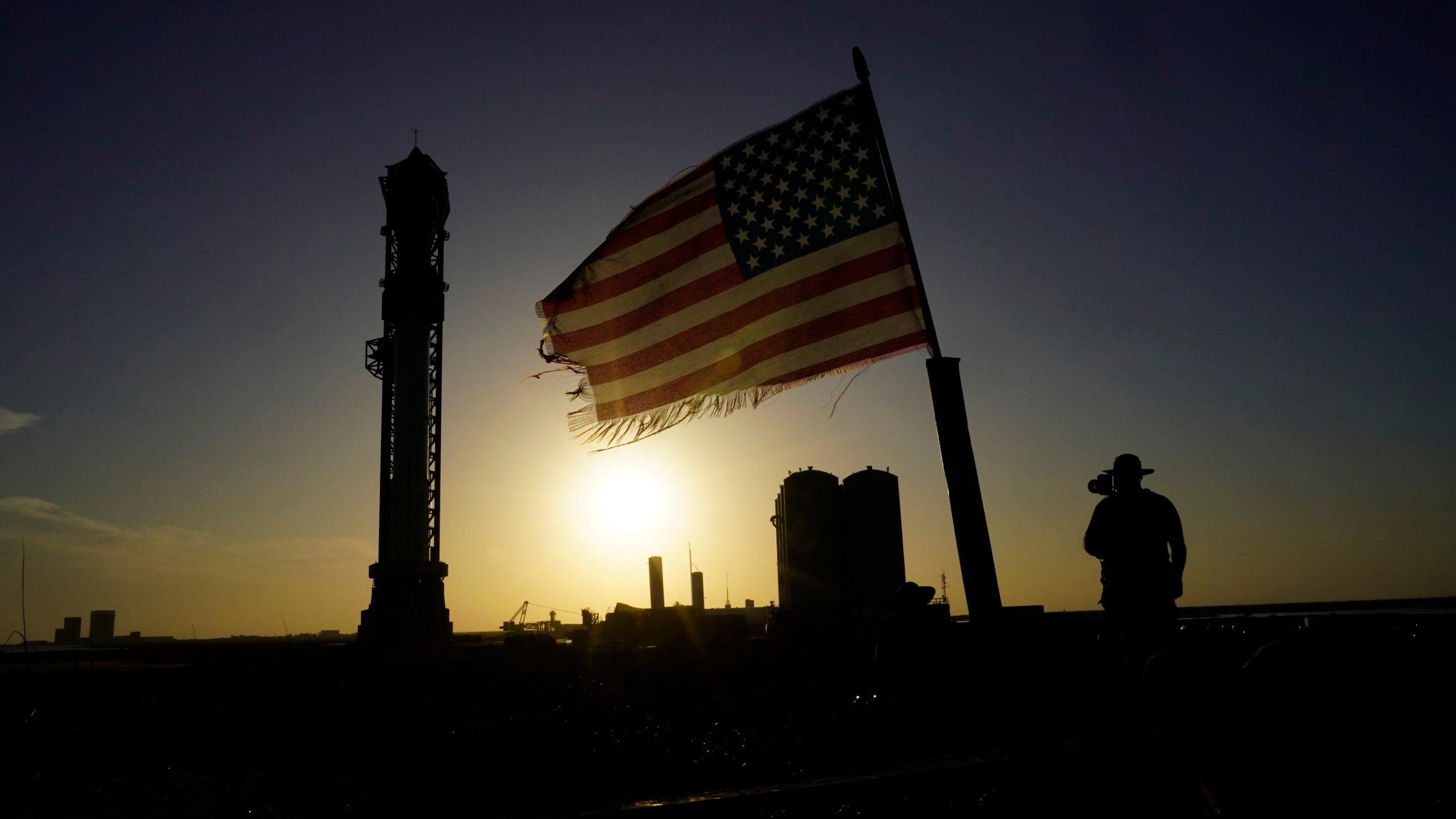 Onlookers watch as SpaceX's Starship, the world's biggest and most powerful rocket, stands ready for launch in Boca Chica, Texas, Sunday, April 16, 2023. The test launch is scheduled for Monday. (AP Photo/Eric Gay)