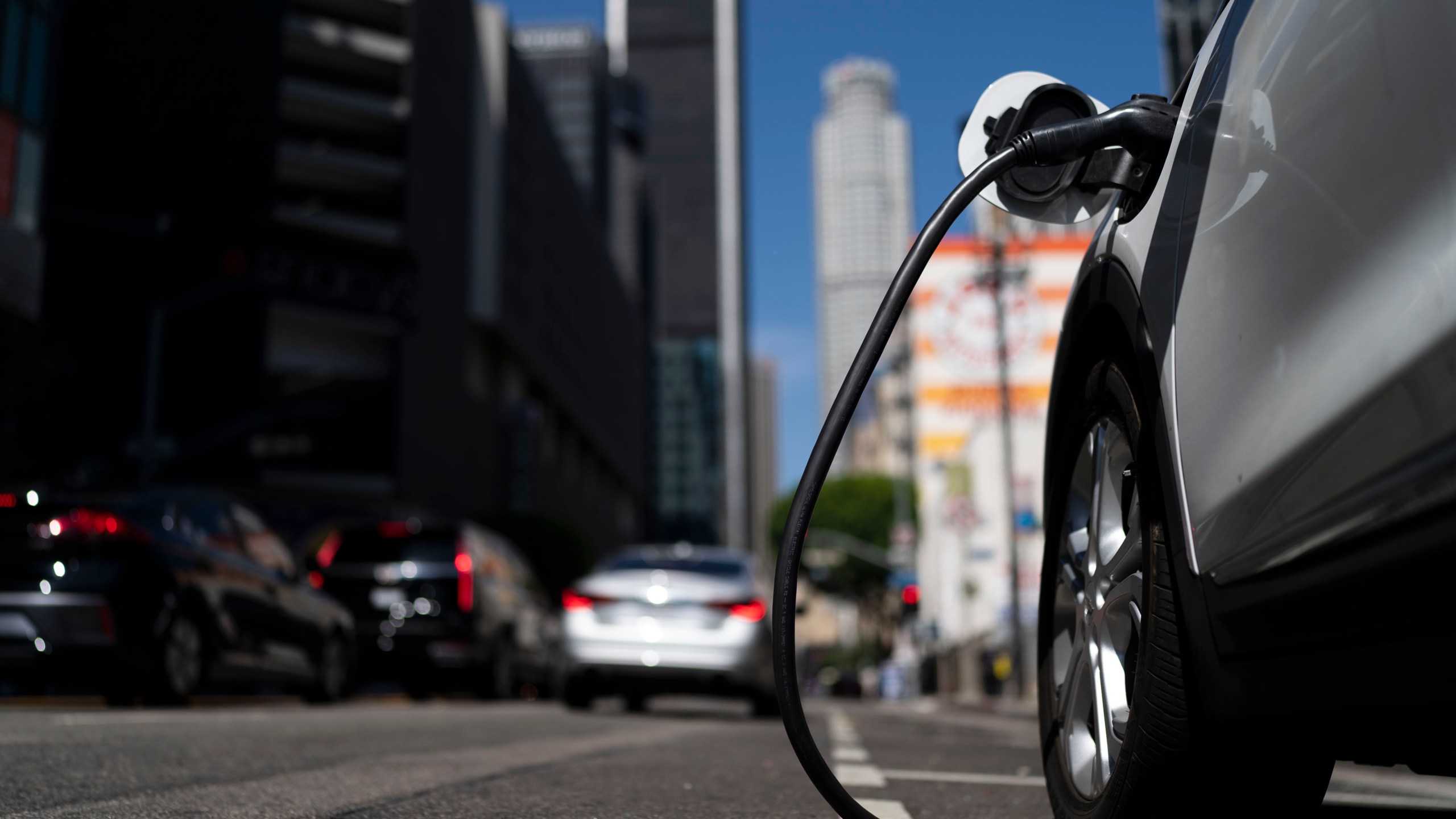 FILE - An electric vehicle is plugged into a charger in Los Angeles, Aug. 25, 2022. Ten electric or plug-in hybrid vehicles will be eligible for a $7,500 U.S. tax credit, while another seven could get $3,750 under new federal rules that go into effect on Tuesday, April 18, 2023. (AP Photo/Jae C. Hong, File)