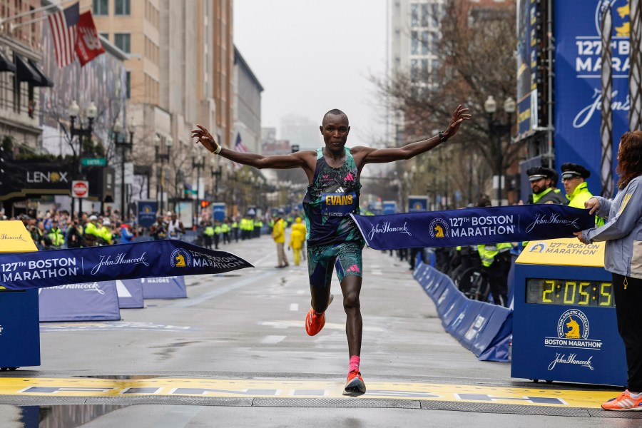 Evans Chebet of Kenya breaks the tape to win the 127th Boston Marathon, Monday, April 17, 2023, in Boston. (AP Photo/Winslow Townson)