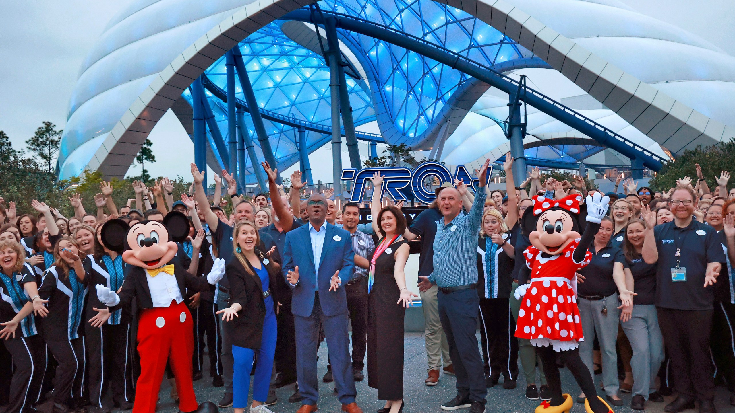 Mickey, Minnie and cast members join Walt Disney World executives in a ceremony marking the official opening of Tron Lightcycle / Run at the Magic Kingdom in Lake Buena Vista, Fla., on Monday, April 3, 2023. The roller coaster opens to guests on Tuesday. From left are Mickey Mouse; Ali Manion, Walt Disney World ambassador; Perry Crawley, Magic Kingdom operations general manager; Melissa Valiquette, vice president of Magic Kingdom; Jason Kirk, senior vice president of operations for Walt Disney World, Minnie Mouse. (Joe Burbank/Orlando Sentinel via AP)