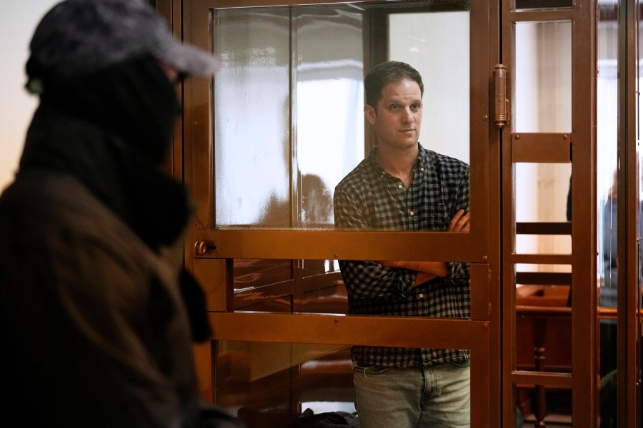 Wall Street Journal reporter Evan Gershkovich stands in a glass cage in a courtroom at the Moscow City Court, in Moscow, Russia, Tuesday, April 18, 2023. (AP Photo/Alexander Zemlianichenko)