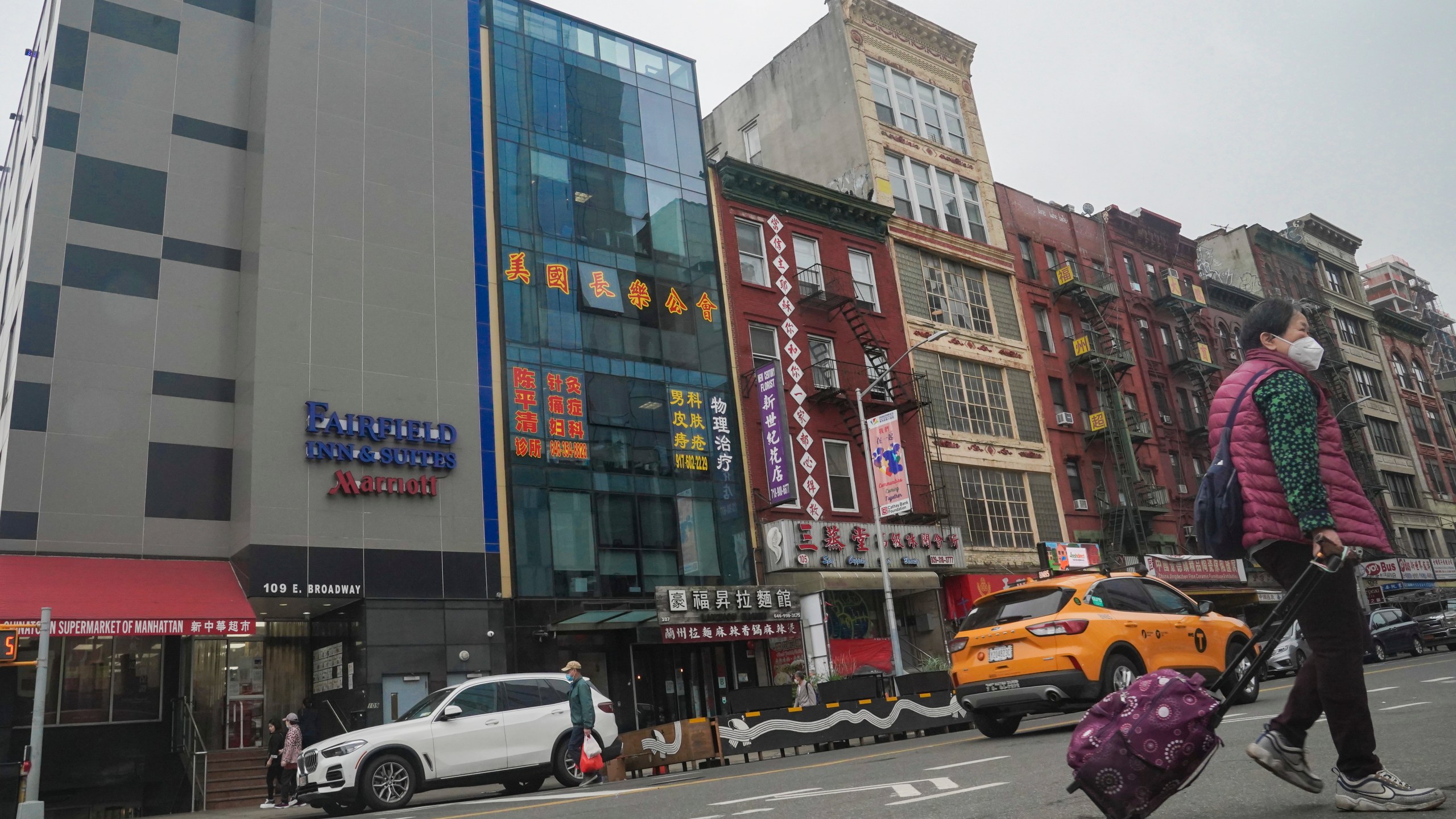 A six story glass facade building, second from left, is believed to be the site of a foreign police outpost for China in New York's Chinatown, Monday April 17, 2023. Justice Department officials say two men have been arrested on charges that they helped establish a secret police outpost in New York City on behalf of the Chinese government. (AP Photo/Bebeto Matthews)