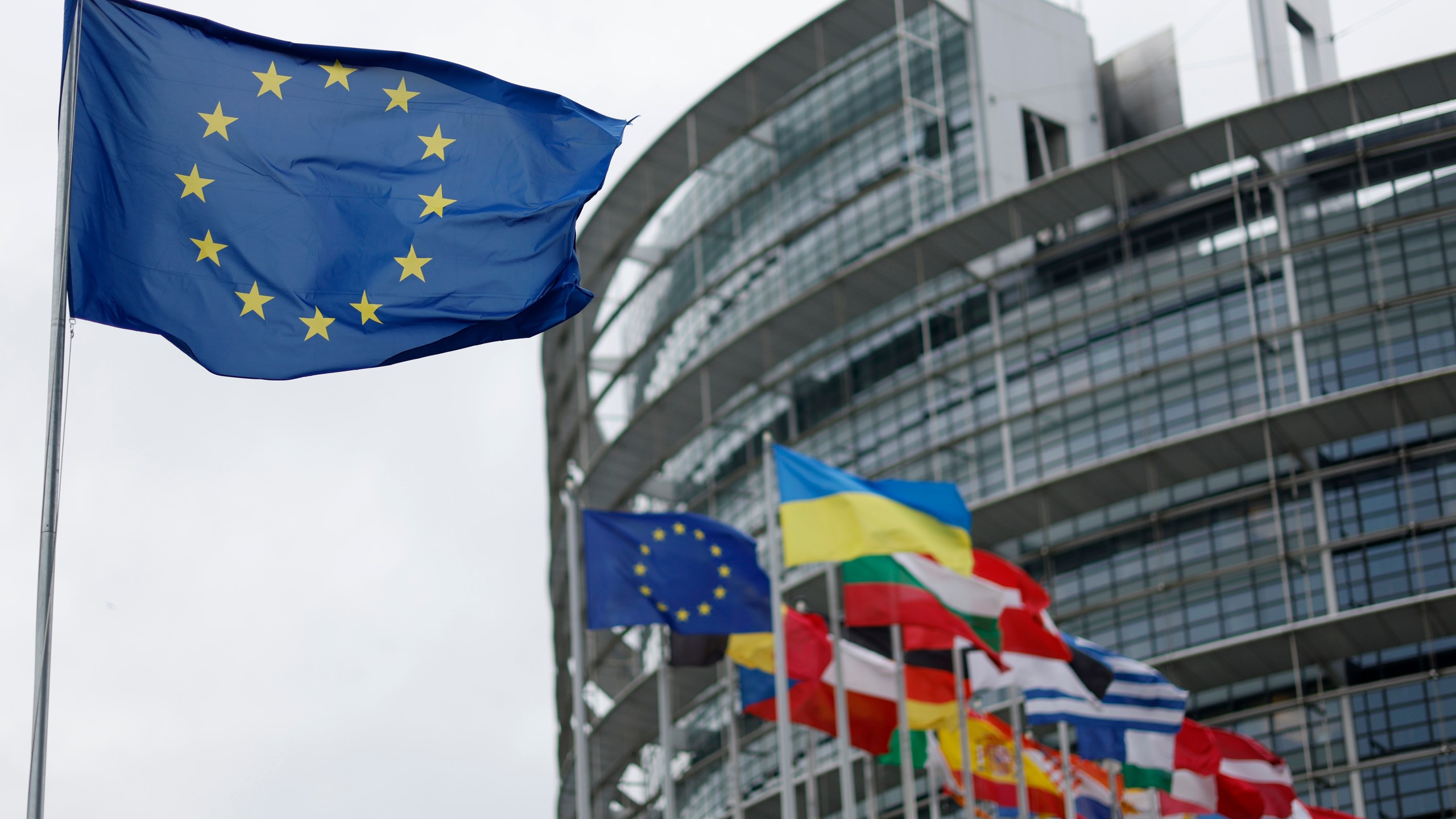 The European flag, left, flies Tuesday, April 18, 2023 at the European Parliament in Strasbourg, eastern France. (AP Photo/Jean-Francois Badias)