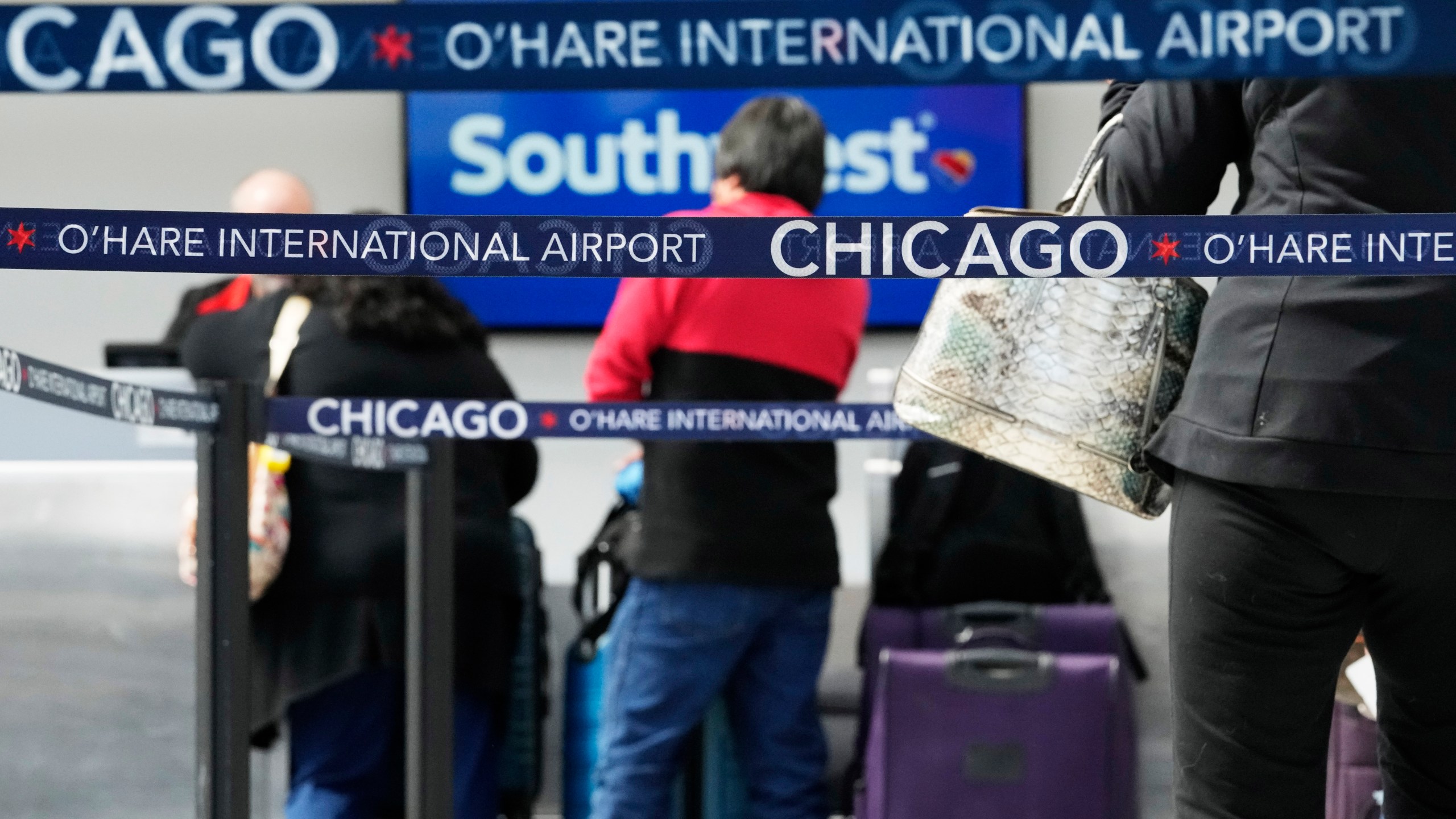 Travelers check in at a Southwest Airlines ticket counter at O'Hare International Airport in Chicago, Tuesday, April 18, 2023. Southwest Airlines planes were grounded nationwide for what the airline called an intermittent technology issue, causing more than 1,700 flight delays Tuesday just four months after the carrier suffered a meltdown over the Christmas travel rush. (AP Photo/Nam Y. Huh)