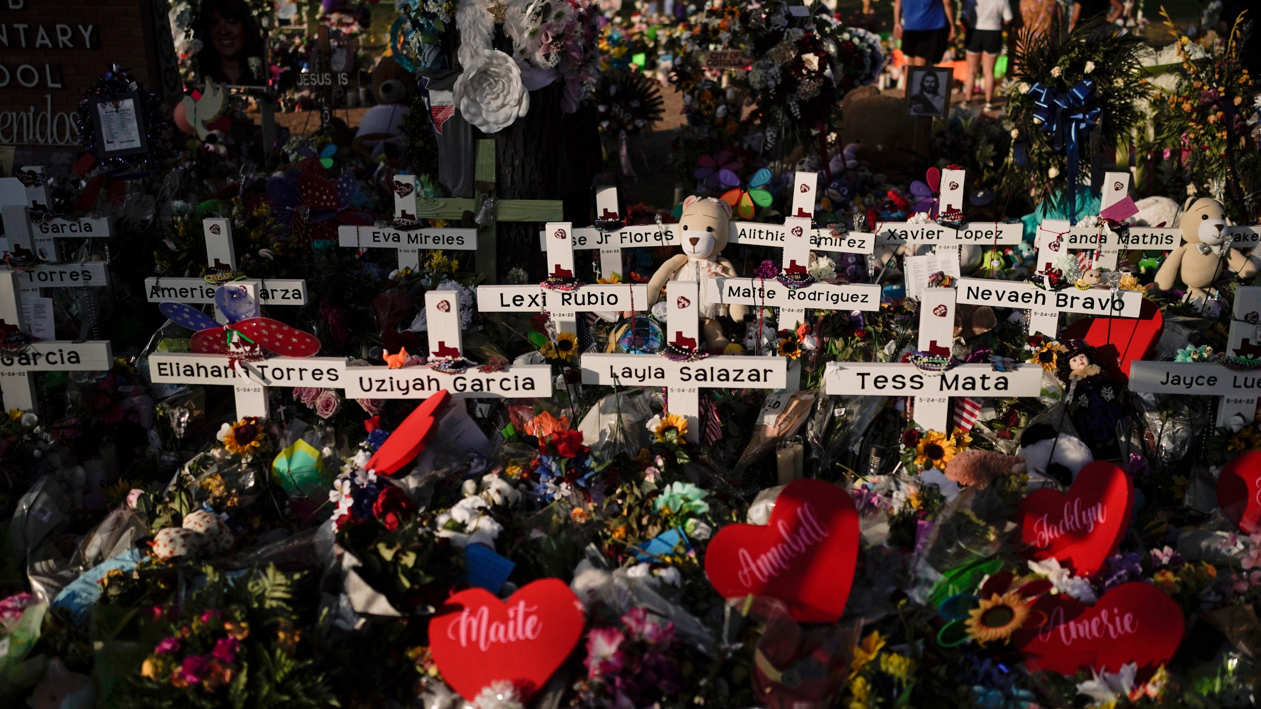 FILE - Flowers are piled around crosses with the names of the victims killed in a school shooting as people visit a memorial at Robb Elementary School to pay their respects May 31, 2022, in Uvalde, Texas. For the first time since the Uvalde school massacre, Texas Republican lawmakers on Tuesday, April 18, 2023, allowed proposals for stricter gun laws to get a hearing in the state Capitol — even though new restrictions have almost no chance of passing. (AP Photo/Jae C. Hong, File)