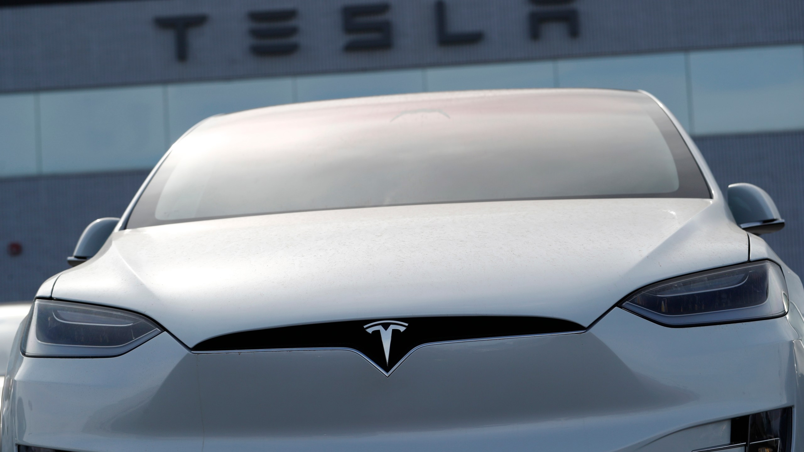 FILE-In this April 15, 2018, file photo, an unsold 2018 Model X 100d sits on a Tesla dealer's lot in the south Denver suburb of Littleton, Colo. Tesla reports earnings on Wednesday, April 19, 2023. (AP Photo/David Zalubowski, File)