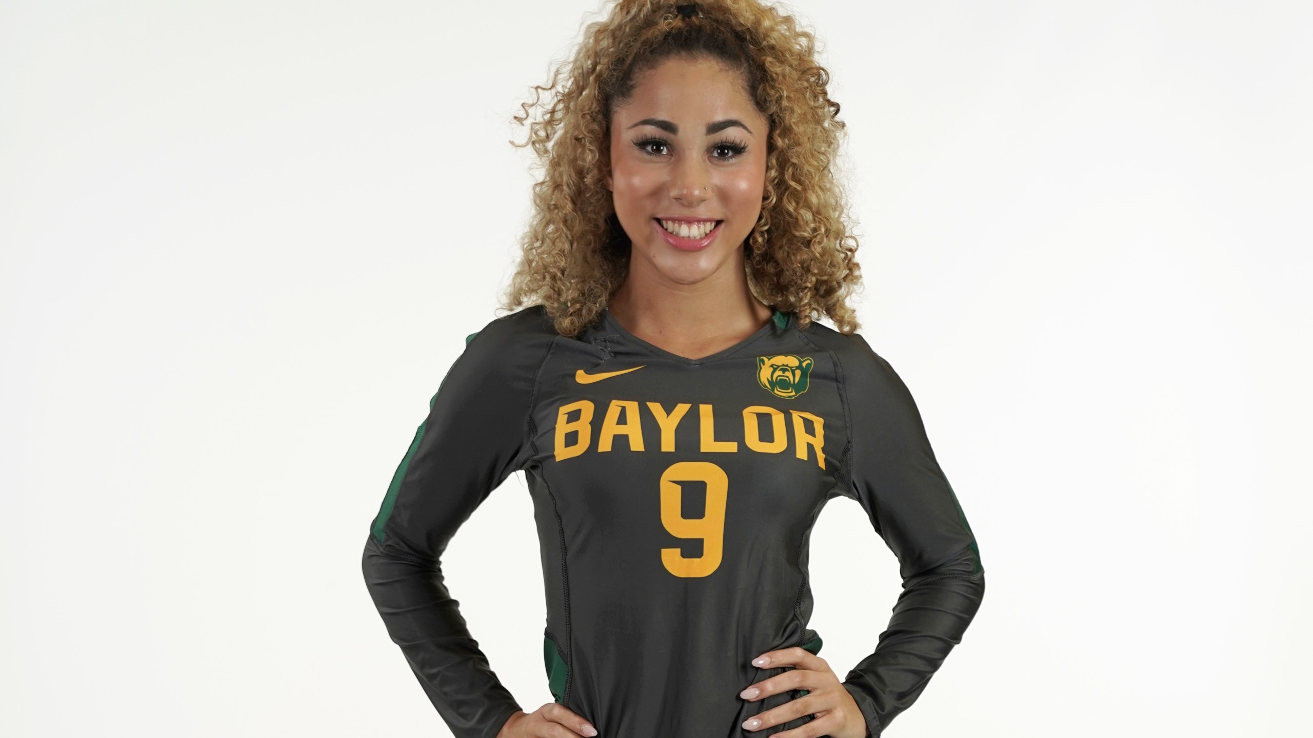 In this photo provided by Baylor University, Payton Washington poses in an undated photo wearing Baylor University attire. Washington was one of two cheerleaders shot and wounded by a man in a Texas supermarket parking lot after one of them said she mistakenly got into his car thinking it was her own. (Baylor University via AP)