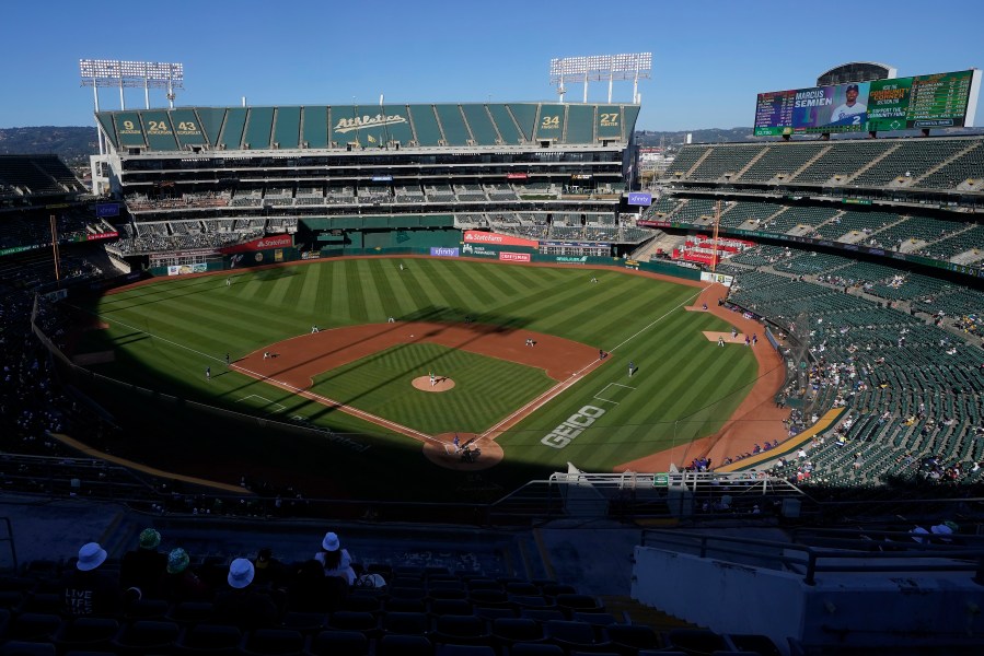 FILE - People watch a baseball game at Oakland Coliseum between the Oakland Athletics and the Texas Rangers in Oakland, Calif., July 23, 2022. The Athletics have signed a binding agreement to purchase land for a new retractable roof stadium in Las Vegas after being unable to build a new venue in the Bay Area. Team president Dave Kaval said Wednesday, April 19, 2023, that the team finalized the deal to buy the 49-acre site last week close to the Las Vegas Strip. (AP Photo/Jeff Chiu, File)