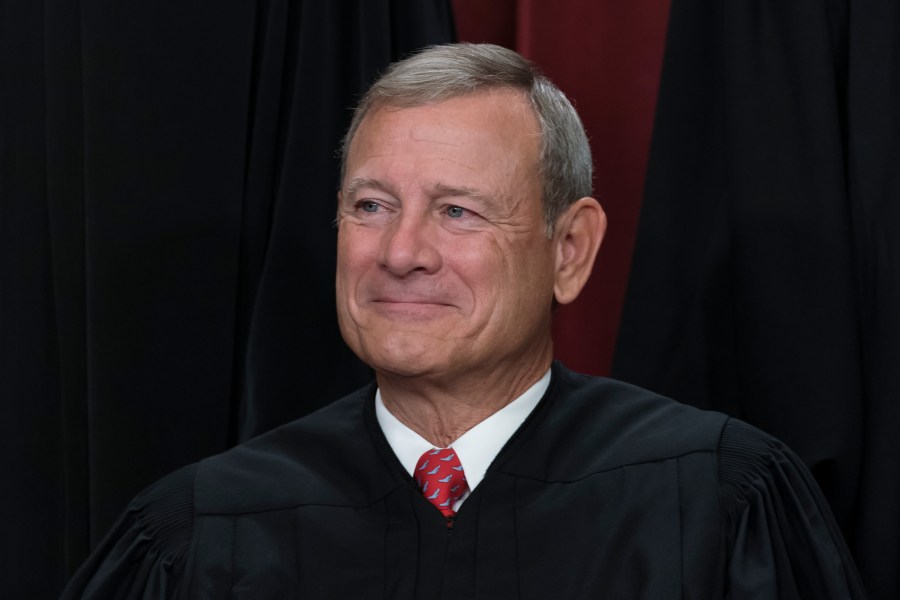 FILE - Chief Justice of the United States John Roberts joins other members of the Supreme Court as they pose for a new group portrait, at the Supreme Court building in Washington, Oct. 7, 2022. The Democratic chairman of the Senate Judiciary has invited Supreme Court Justice John Roberts to testify next month at a hearing on ethics standards. (AP Photo/J. Scott Applewhite, File)