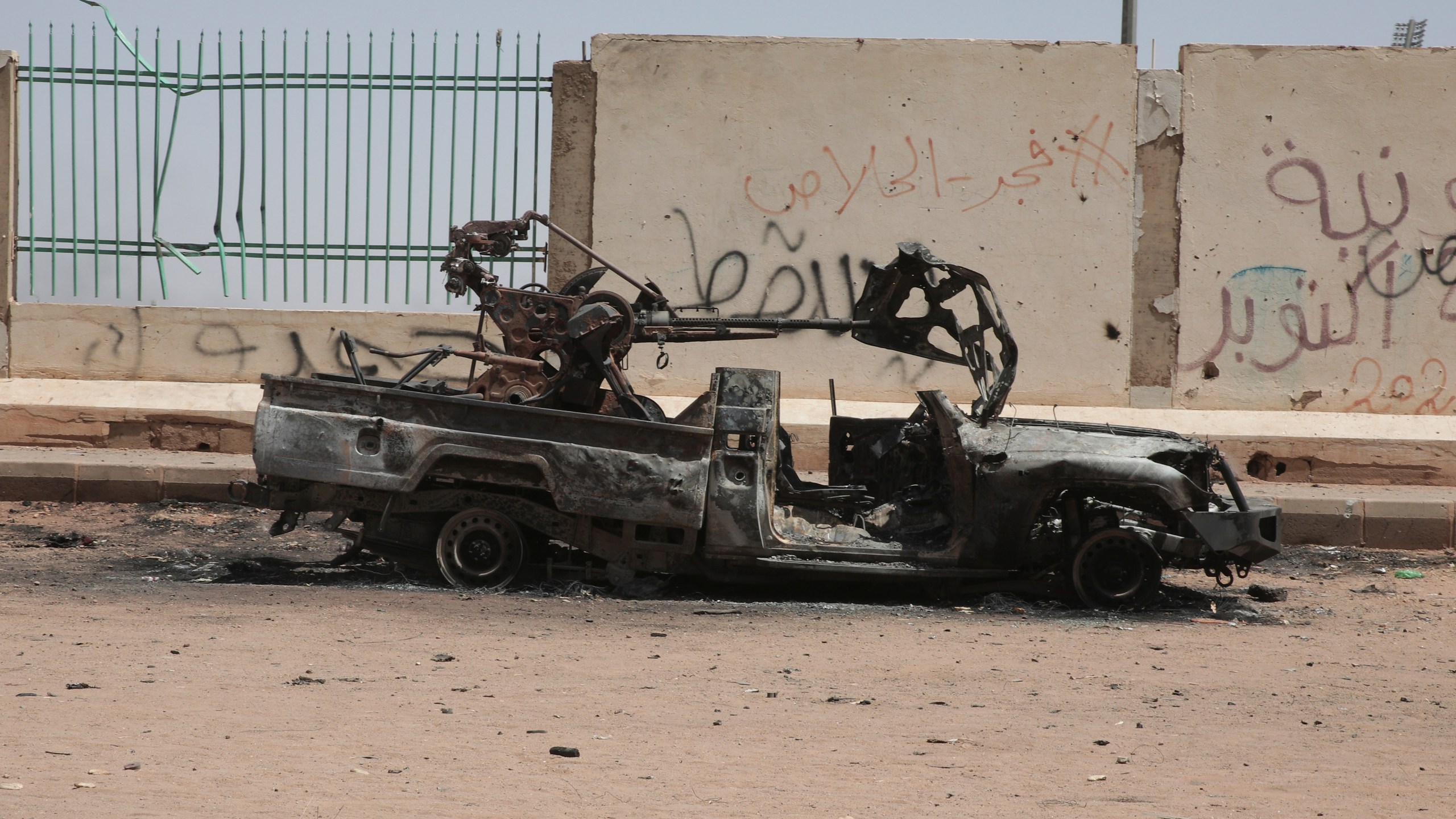 A destroyed military vehicle is seen in southern in Khartoum, Sudan, Thursday, April 20, 2023. The latest attempt at a cease-fire between the rival Sudanese forces faltered as gunfire rattled the capital of Khartoum. Through the night and into Thursday morning, gunfire could be heard almost constantly across Khartoum. (AP Photo/Marwan Ali)