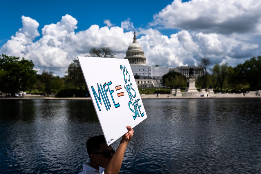 With the U.S. Capitol in the background, a protester holds a sign in support of mifepristone as they march past the capitol following a Planned Parenthood rally in support of abortion access outside the Supreme Court on Saturday, April. 15, 2023, in Washington. (AP Photo/Nathan Howard)