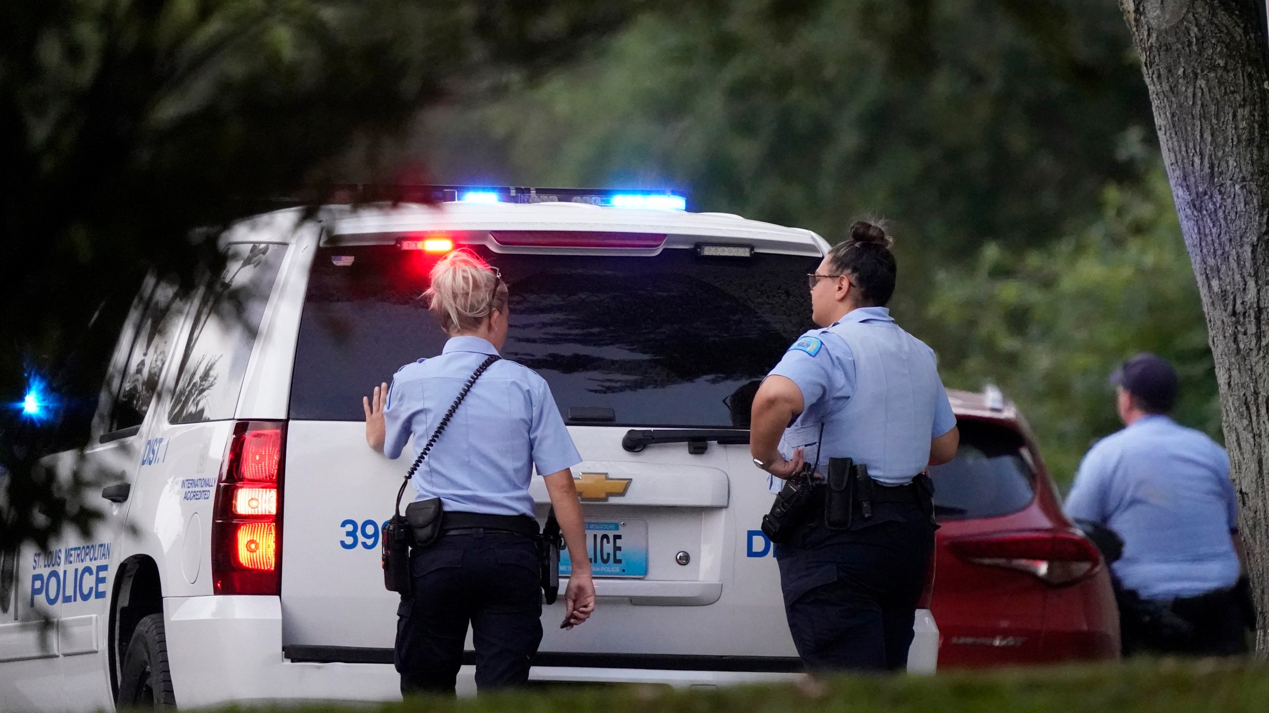 FILE - Police take up positions near the scene of a shooting Saturday, Aug. 29, 2020, in St. Louis. Ten years after gaining local control of its police for the first time since the Civil War, the city of St. Louis has even more murders than before — and Missouri lawmakers are again considering a state takeover of the police force. (AP Photo/Jeff Roberson, File)