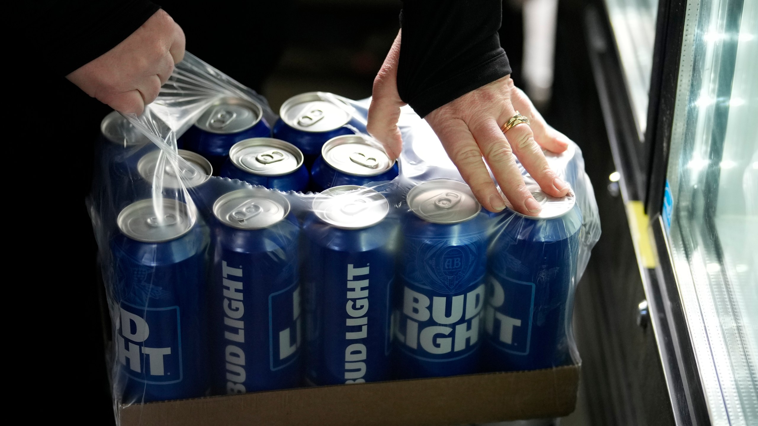 A stadium worker opens a case of Bud Light beer before a baseball game between the Philadelphia Phillies and the Seattle Mariners, Tuesday, April 25, 2023, in Philadelphia. (AP Photo/Matt Slocum)