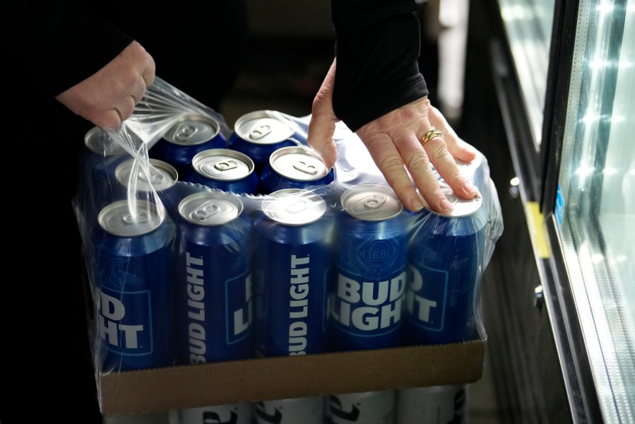 A stadium worker opens a case of Bud Light beer before a baseball game between the Philadelphia Phillies and the Seattle Mariners, Tuesday, April 25, 2023, in Philadelphia. (AP Photo/Matt Slocum)