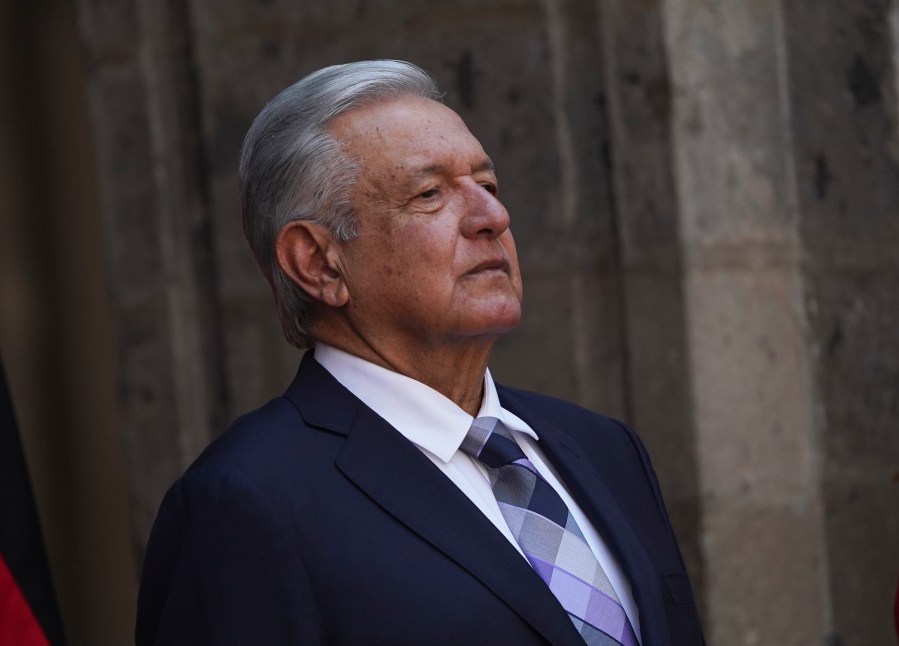 FILE - Mexican President Andres Lopez Obrador stands at the National Palace during a ceremony in Mexico City, Sept. 20, 2022. Lopez Obrador suspended a tour of the Yucatan peninsula Sunday, April 23, 2023, after acknowledging he tested positive for the cornavirus, having previously suffered two bouts of COVID-19. (AP Photo/Marco Ugarte, File)