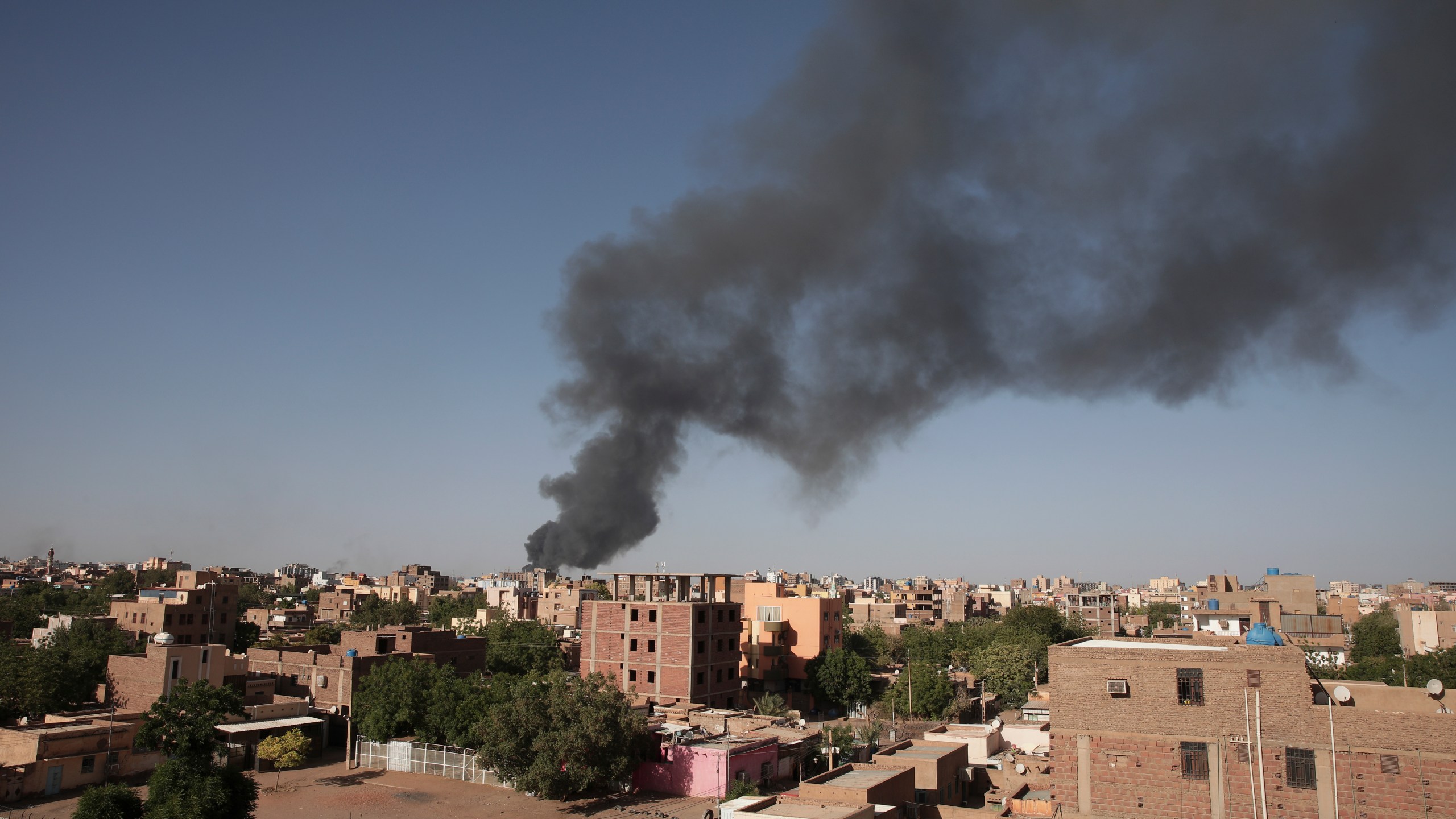 FILE - Smoke is seen in Khartoum, Sudan, Wednesday, April 19, 2023. Warring factions trying to seize control of the east African nation of Sudan have plunged the country into chaos, and thousands are fleeing the capital of Khartoum and nearby battle zones. Some countries, including the U.S., have shuttered their embassies and many are coordinating daring evacuations of their staffs and other residents in an array of convoys, flights and frantic getaway drives. (AP Photo/Marwan Ali, File)