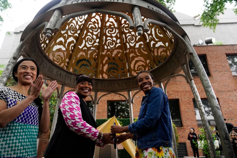 The Rev. Bernice King, center, daughter of the Rev. Martin Luther King Jr. and Coretta Scott King, granddaughter of Rev. Martin Luther King Jr., Yolanda Renee King, right, and artist Saya Woolfalk, left, attend during the dedication of the Coretta Scott King Peace and Meditation Garden and monument on Thursday, April 27, 2023, in Atlanta. (AP Photo/Brynn Anderson)