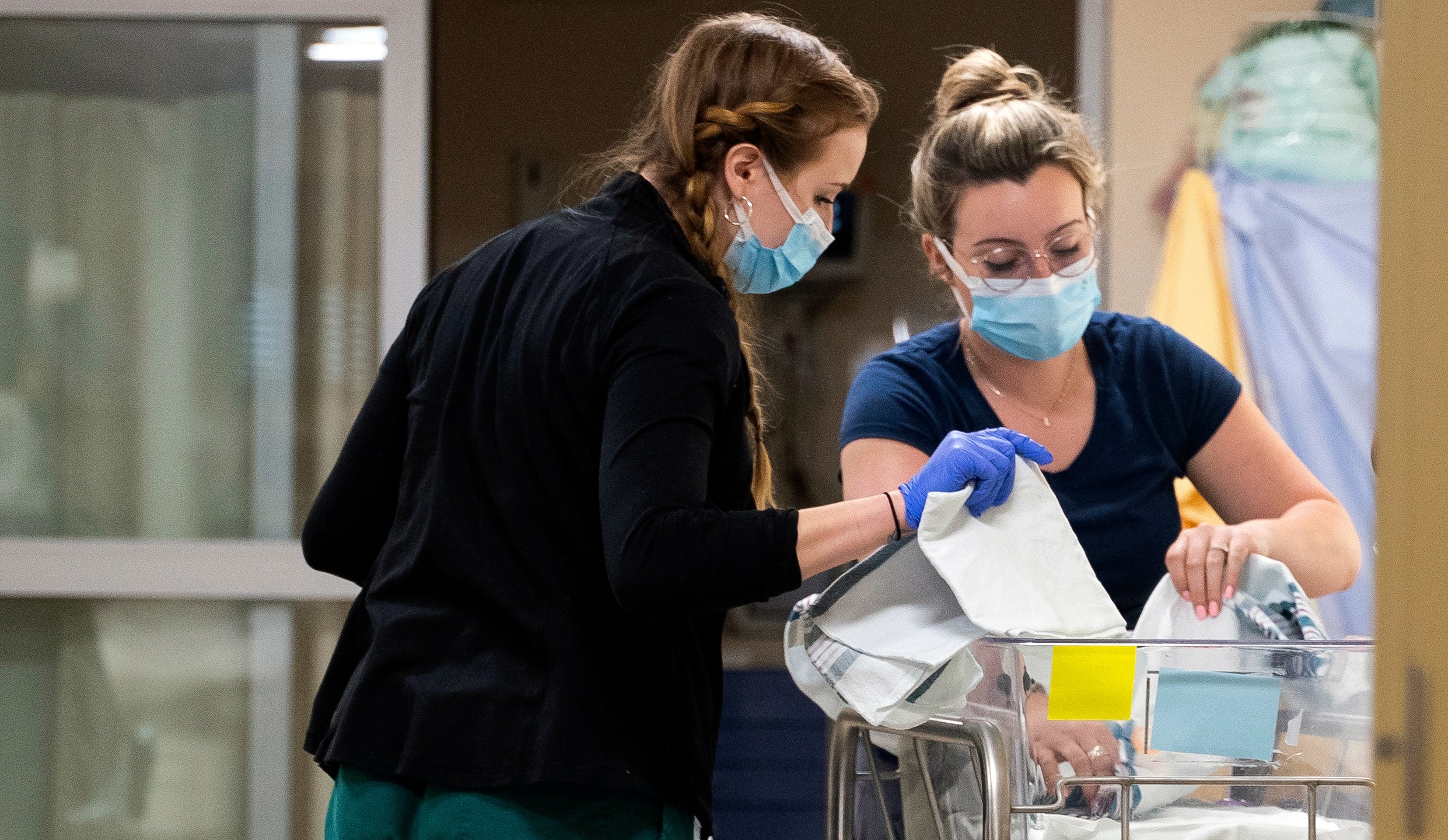 In a photo provided by the University of Vermont Health Network, licensed nursing assistant Jordan Bushy, right, and a student nurse care for newborns at the University of Vermont Children’s Hospital in Burlington, Vt., Friday, April 28, 2023. Research led by Dr. Leslie Young of the children’s hospital has found that babies born to opioid users had shorter hospital stays and needed less medication when their care emphasized parent involvement, skin-to-skin contact and a quiet environment. (Ryan Mercer/University of Vermont Health Network via AP)