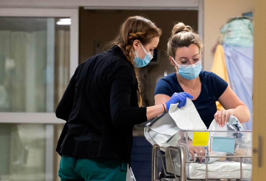 In a photo provided by the University of Vermont Health Network, licensed nursing assistant Jordan Bushy, right, and a student nurse care for newborns at the University of Vermont Children’s Hospital in Burlington, Vt., Friday, April 28, 2023. Research led by Dr. Leslie Young of the children’s hospital has found that babies born to opioid users had shorter hospital stays and needed less medication when their care emphasized parent involvement, skin-to-skin contact and a quiet environment. (Ryan Mercer/University of Vermont Health Network via AP)